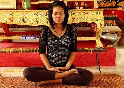 Woman meditating in a blissful pose